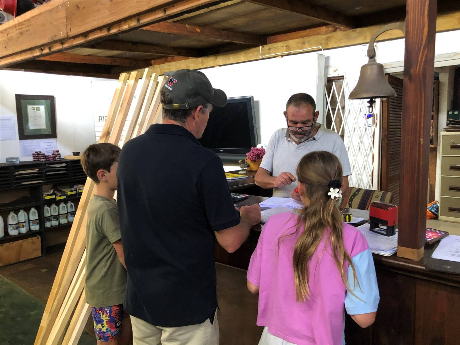 A father and two children being served at the counter