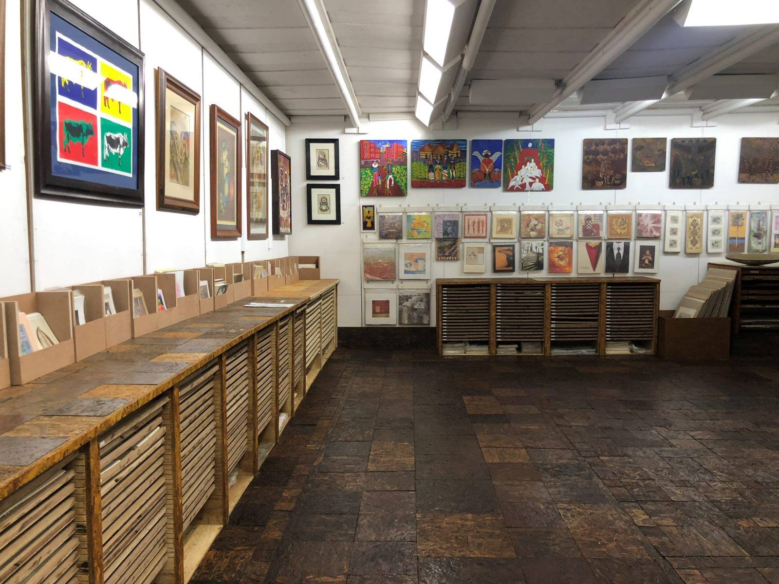 The framing showroom at Shongweni, art on the walls and sample drawers